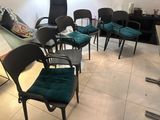 a room with chairs, a table, and a television in it