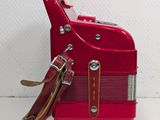 a red suitcase that is sitting on a white surface