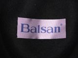 the back of a black jacket with a purple label on it