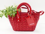 a red basket with a plant in it and a tag on it