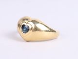 an image of a gold ring with a blue stone in the middle