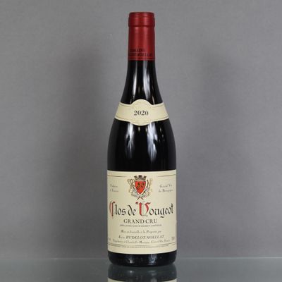 a bottle of red wine sitting on top of a glass table