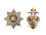 two badges of the british army are shown on a white surface