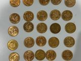 some gold coins sitting on top of a white table