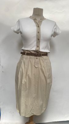 beige skirt and white shirt on a mannequin stand