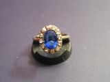 an image of a ring with a blue stone in it