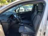 the interior of a car with the door open and the driver ' s seat down