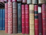 many old books on a shelf in a library