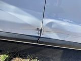 a close up of a car with a denting on the side of it
