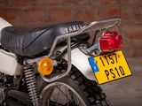 a motorcycle that is parked in front of a brick wall