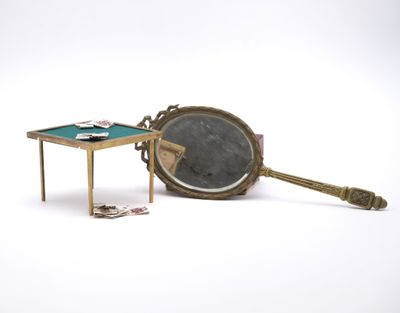 a small table with a mirror and a mirror on it