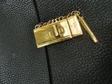 a close up of a purse with a chain on it