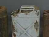 three old metal cans sitting next to each other on top of a table