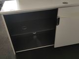 a white desk with drawers and a cabinet with baskets on it