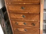 a wooden chest of drawers with a marble top
