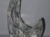 a glass sculpture of a bird on a table
