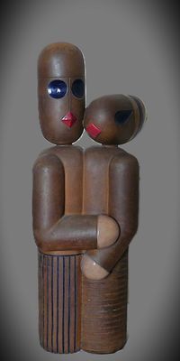 wooden figurine of a man and a woman holding each other