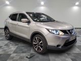 the silver nissan suv is parked on a checkered tile floor