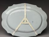 a white plate with a clock on it on a table
