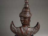 a bronze statue of a man with a hat on his head