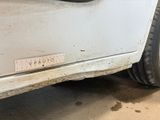 a close up of a white car with a sticker on it