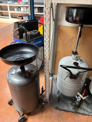a black frying pan and a black frying pan sitting on top of a metal table