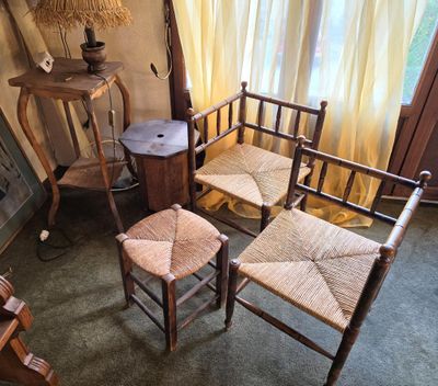 four chairs and a table in the corner of a room