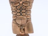 a bronze statue of a torso with a knife next to it