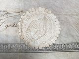 an old document with a stamp on it sitting on a table