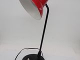 an image of a red table lamp with a cord plugged into it