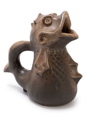 a brown vase with a fish on it on a white surface