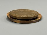 two coins sitting on top of each other on a table