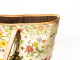 a white bag with a floral design on it
