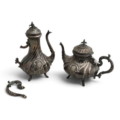 pair of antique silver teapots and a teapot on a white background