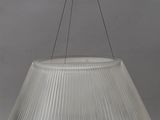 a white lamp shade hanging from a ceiling fixture