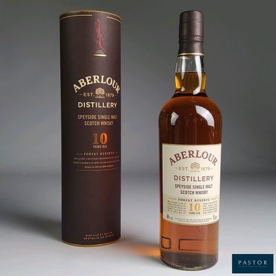 a bottle of whisky next to a cardboard box on a table