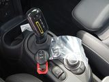 a cell phone in the center of a car ' s gear box