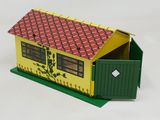 a small yellow house with a red roof and a green door