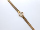 a gold watch with a white dial on a gold bracelet
