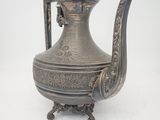 an antique silver tea pot with a handle on a white background