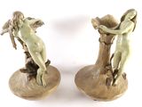 two statues of a woman sitting on a tree stump