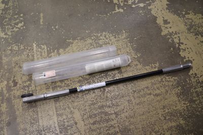 a pen that is laying on the floor next to a tube