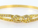 a gold bracelet with two hearts and diamonds on it