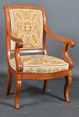 a wooden chair with a yellow and white upholstered seat