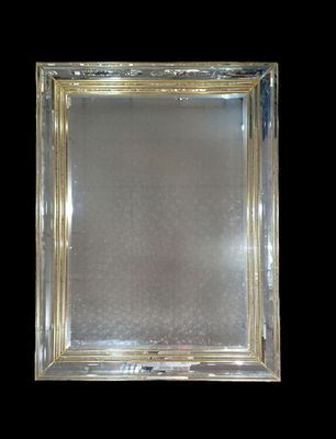 an antique silver plated mirror with a gold border
