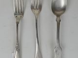 three silver spoons and a fork on a white surface