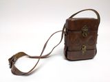 brown leather purse on white background with strap around it