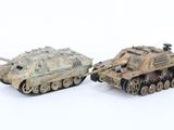two toy tanks sitting next to each other on a white surface