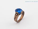 a close up of a ring with a blue stone on it