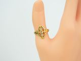 an image of a woman ' s hand with a gold ring on it